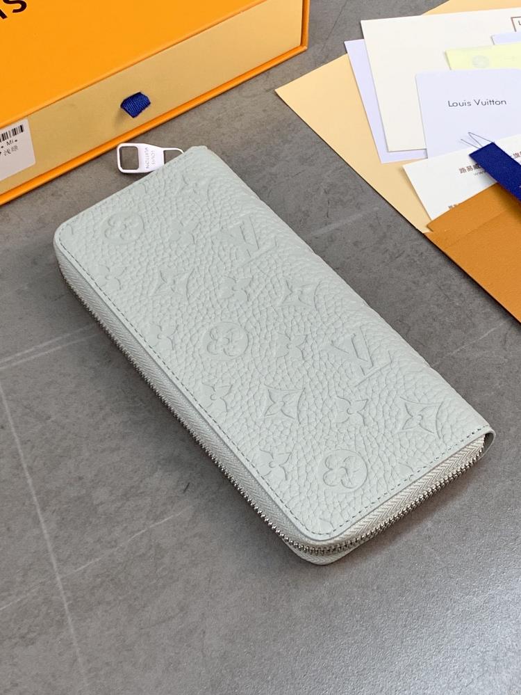 The M82597 Light Green Zippy Vertical wallet features a soft Taurillon leather embossed Mo