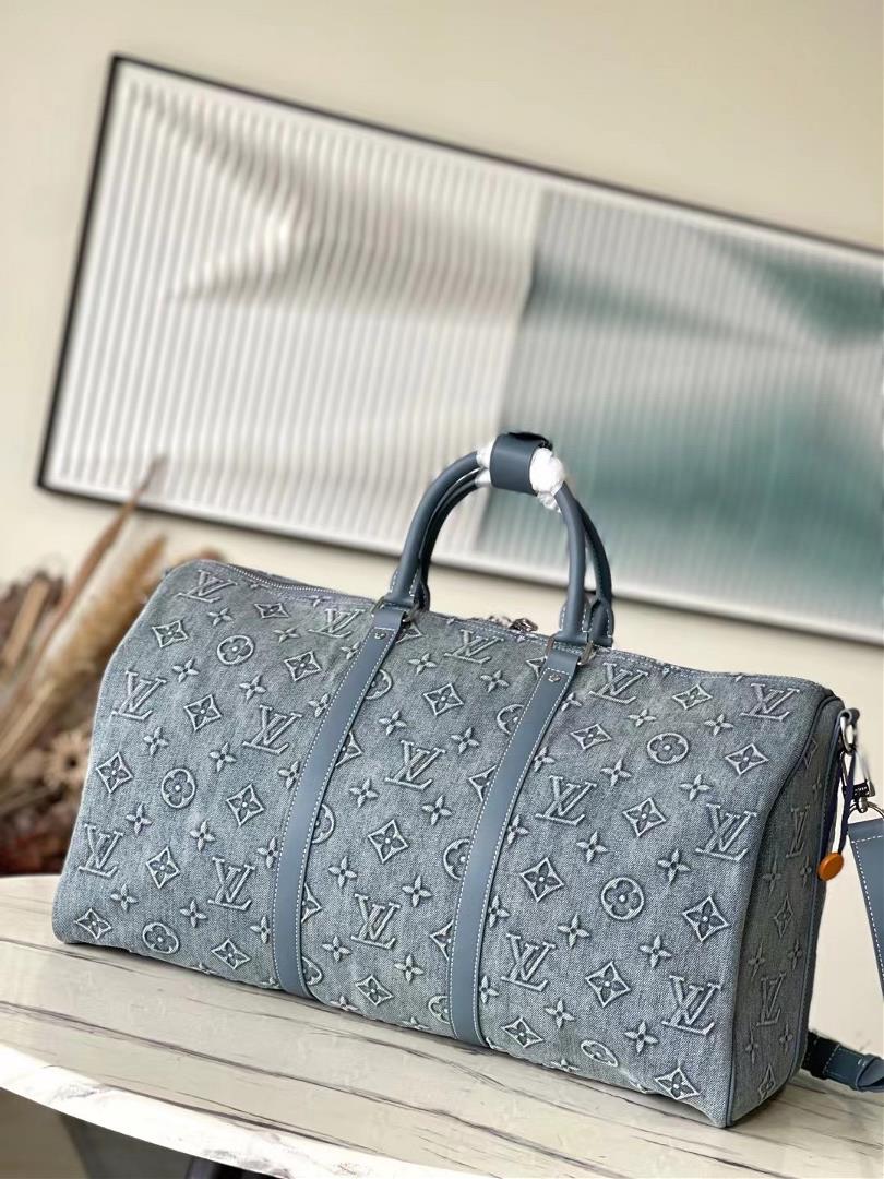 M22532 denim This Keepall Bandoulire 50 travel bag is embossed with Monogram pattern on fa