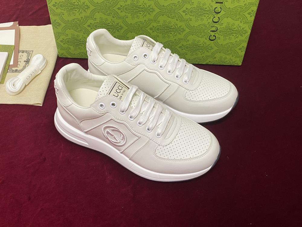 Gui Low Top Sneaker Collection This sneaker features a top layer of leather and classic perforated design with an embroidered brand logo on the tail